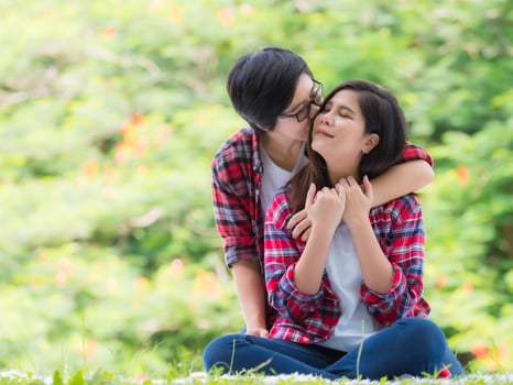 Asian female couples LGBT sitting and relax in the garden and embrace each other in love and happiness photo