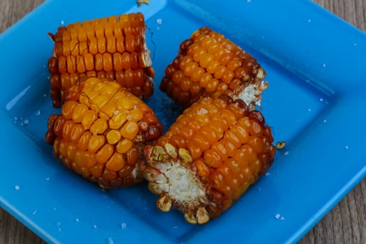 Grilled corn on wood photo