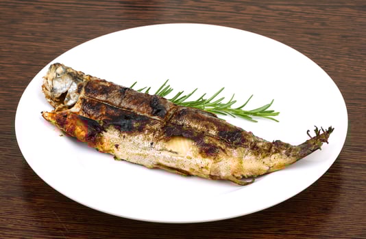 Grilled trout on wood photo