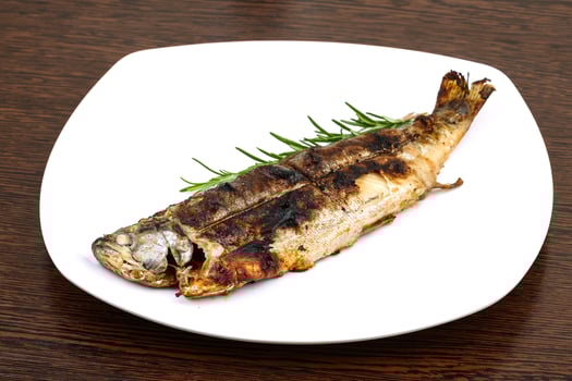 Grilled trout on wood photo