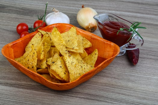 Nachos in a bowl on wooden background photo