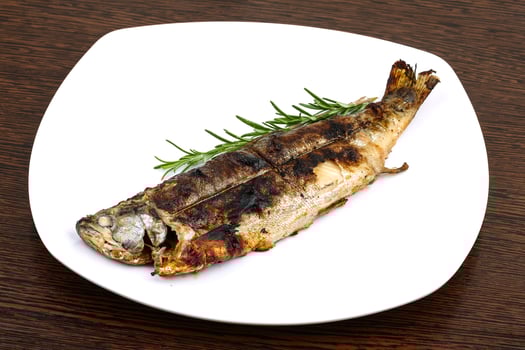 Grilled trout on wood photo