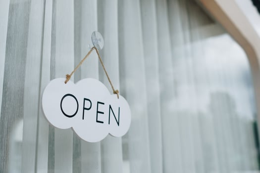 A business sign that says Open on cafe or restaurant hang on door at entrance. photo