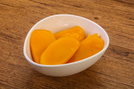 Sweet mango slices in syrop photo