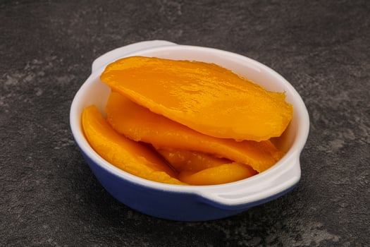 Sweet mango slices in syrop photo