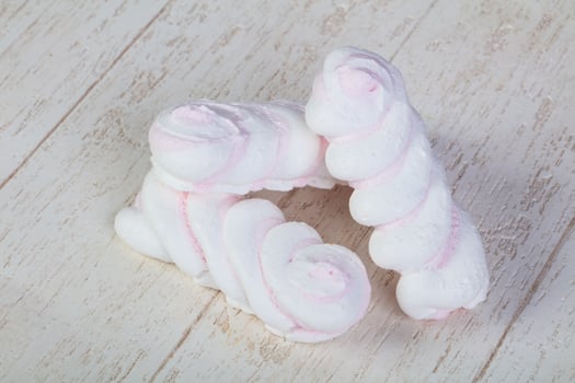 Delicious meringues on wooden background photo