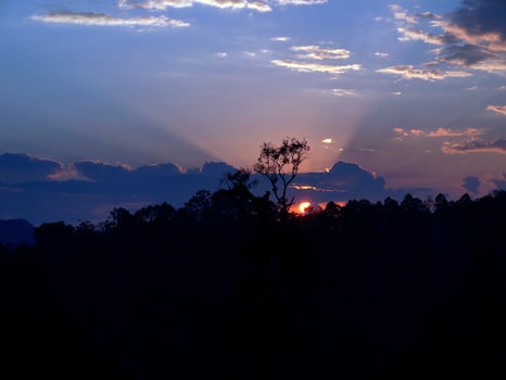 Sunset dawn mountain raylighs bluesky clouds silhouette trees photo