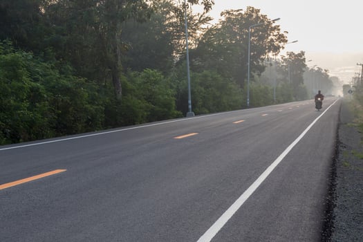 Asphalt road with sun rising in the countryside. photo