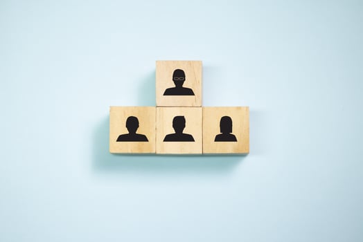 Top view wooden blocks with people icon set  to podium. Concept for company and human resorce manangement. photo