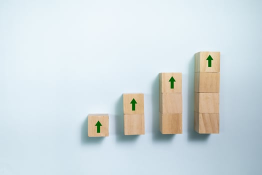 Top view wooden blocks set to growth graph with up arrow. Concept for money and success business. photo