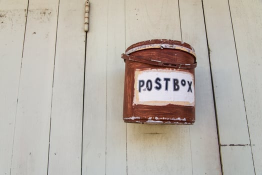 The red vintage postbox on the white old wooden door, Pai, Maehongson, Thailand photo