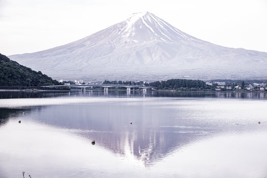 The reflection of beautiful Fuji mountain with bridge in lake  in the summer, the famous landmark and attraction place of tourists who have a long holiday in Japan, Lake Kawaguchiko photo