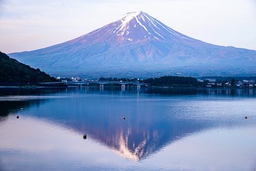 The reflection of beautiful Fuji mountain with bridge in lake  in the summer, the famous landmark and attraction place of tourists who have a long holiday in Japan, Lake Kawaguchiko photo