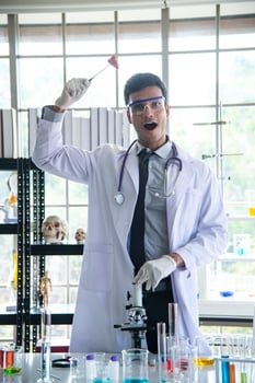 Young scientist biologist or researcher putting personal protective equipments to prevent infection from virus or bacteria disease and testing photo