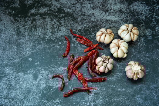 Red dried hot chilli pepper and garlic on gray texture background, Chilli and garlic are ingedient  of Thai food photo