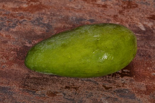 Green tasty mango over wooden background photo