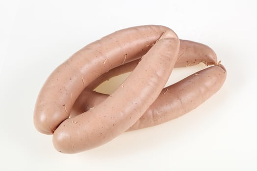 Tasty meat sausages over white background photo