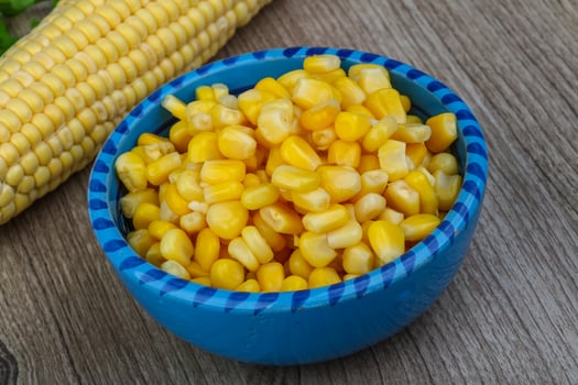 Sweet corn in a bowl on wooden background photo