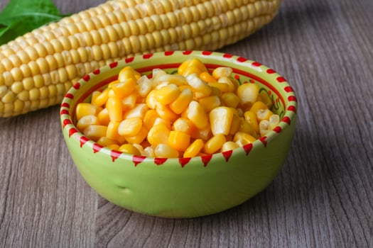 Sweet corn in a bowl on wooden background photo