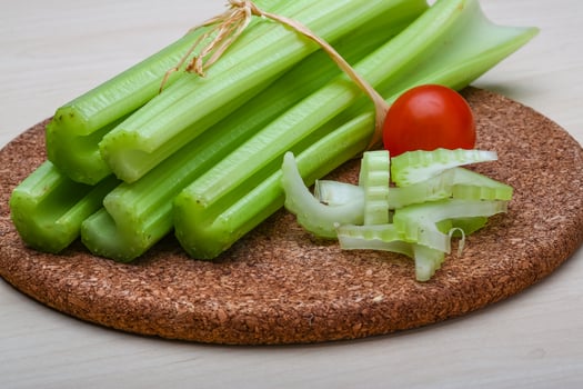 Celery on wooden board and wooden background photo