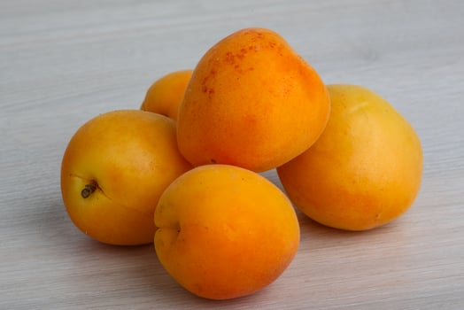 Apricots on wooden background photo