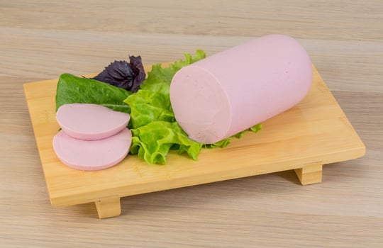 Sausage on wooden board and wooden background photo