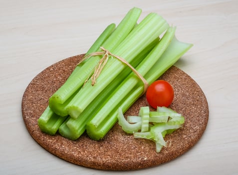 Celery on wooden board and wooden background photo