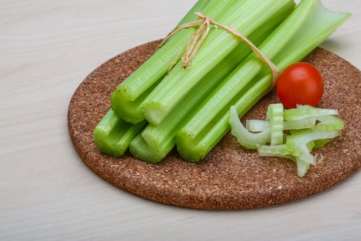 Celery on wooden board and wooden background photo