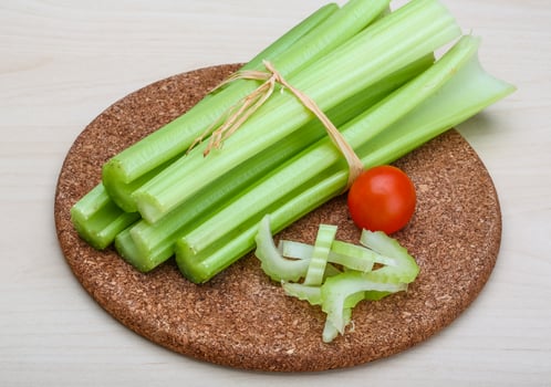 Celery on wooden board and wooden background photo