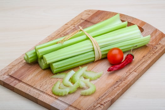 Celery on wooden board and wooden background photo