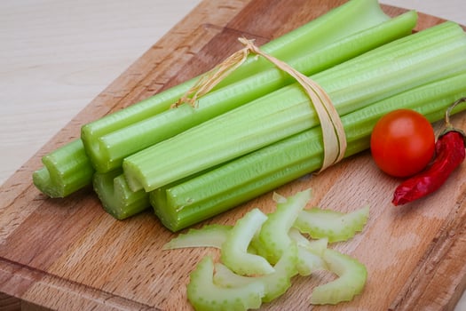 Celery on wooden board and wooden background photo