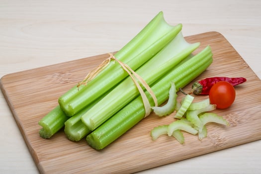 Celery on wooden board and wooden background photo