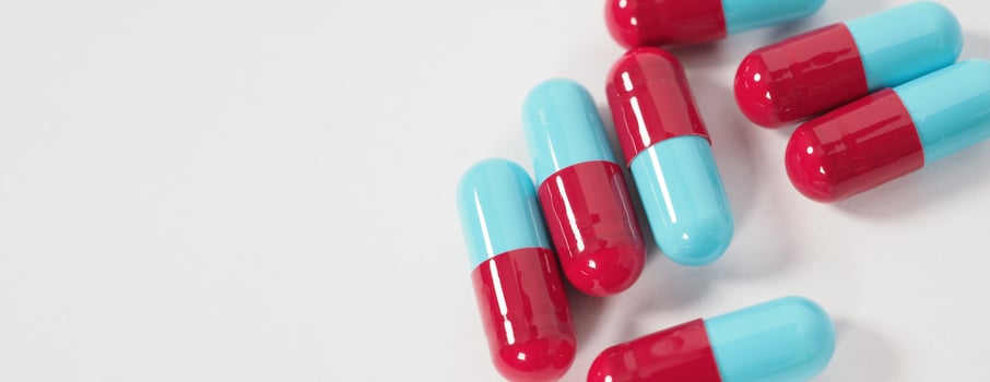 Taking or holding medication pills in hand. Capsule pill on white background. photo