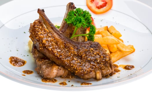 Lamb chops on the plate and white background photo