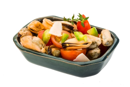 Mussells salad in a bowl on white background photo