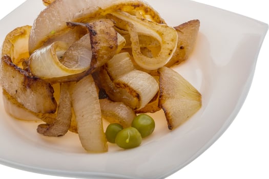 Fried onion on the plate and white background photo