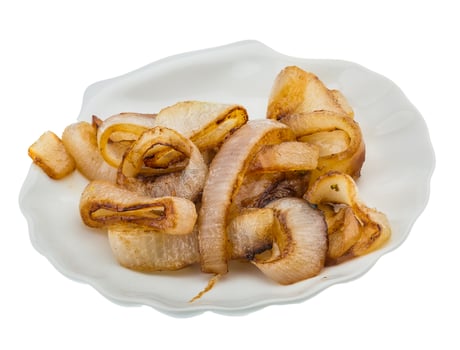 Fried onion on the plate and white background photo