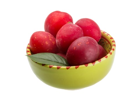 Damson plum in a bowl on white background photo