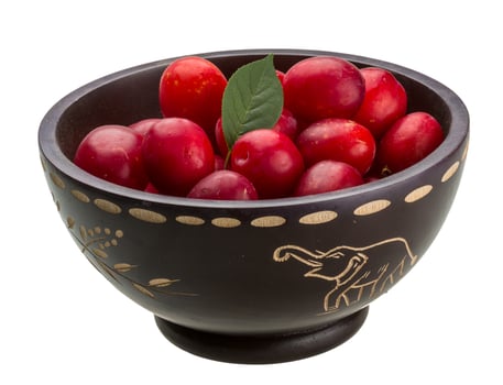 Damson plum in a bowl on white background photo