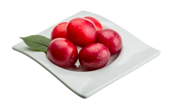 Damson plum in a bowl on white background photo