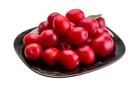 Damson plum on the plate and white background photo