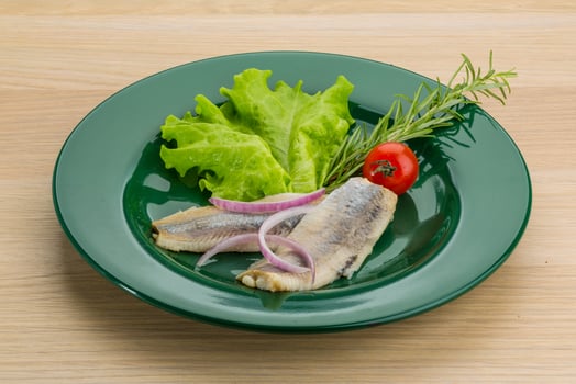 Herring fillet on the plate and wooden background photo