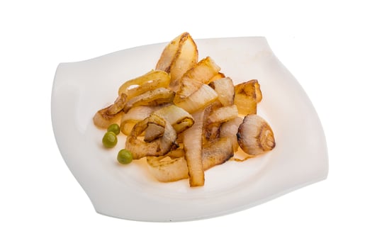Fried onion on the plate and white background photo