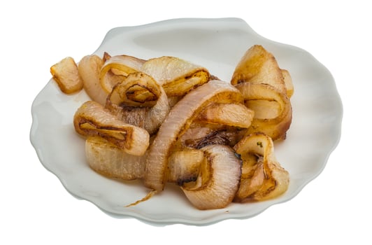 Fried onion on the plate and white background photo