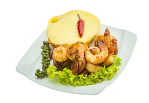 Garlic shrimps with potato on the plate and white background photo