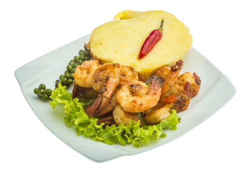 Garlic shrimps with potato on the plate and white background photo