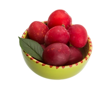 Damson plum in a bowl on white background photo