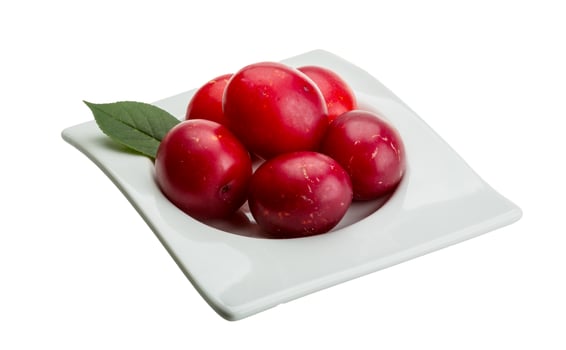 Damson plum in a bowl on white background photo