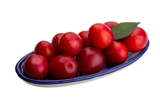 Damson plum in a bowl on white background photo