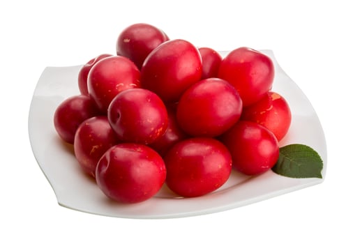 Damson plum on the plate and white background photo